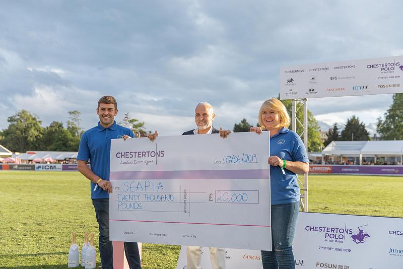 Salah Mussa presents a cheque to Chestertons Foundations